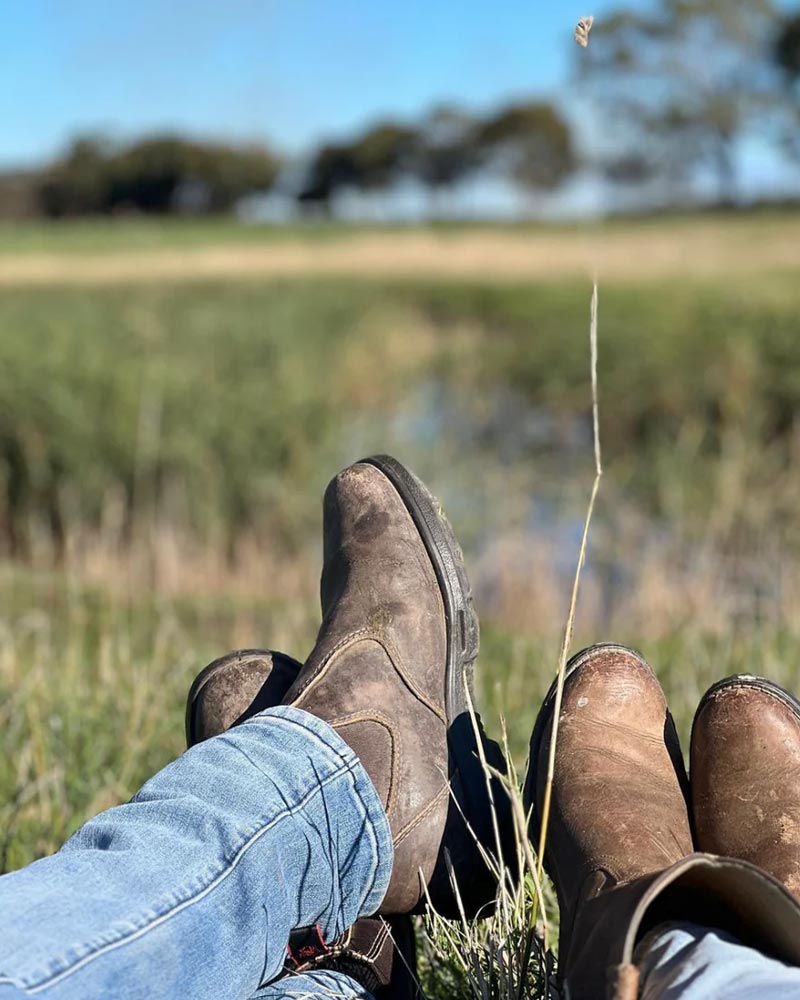 Workers resting in field with boots on